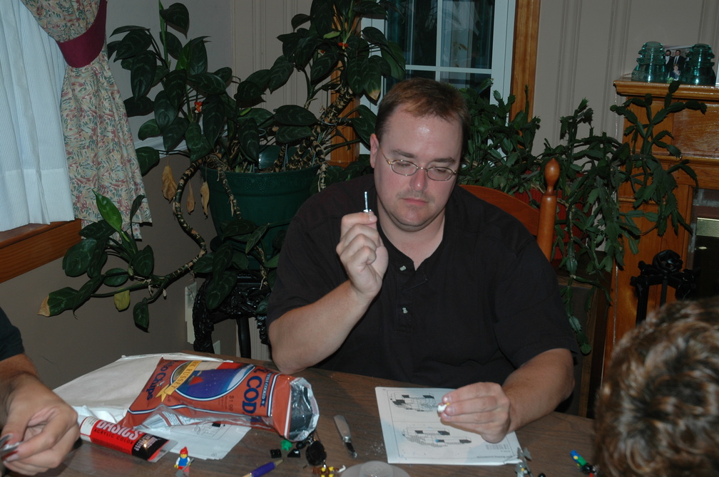 Michael prepares to scratch modern insignia off of LEGO people