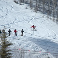 Snowboarder catching some air with onlookers