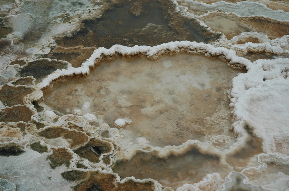a thermal pool surrounded by hardened minerals