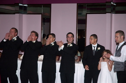 groomsmen applaud the bride and groom