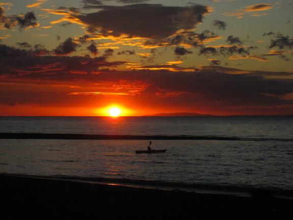 sunset over kayaker